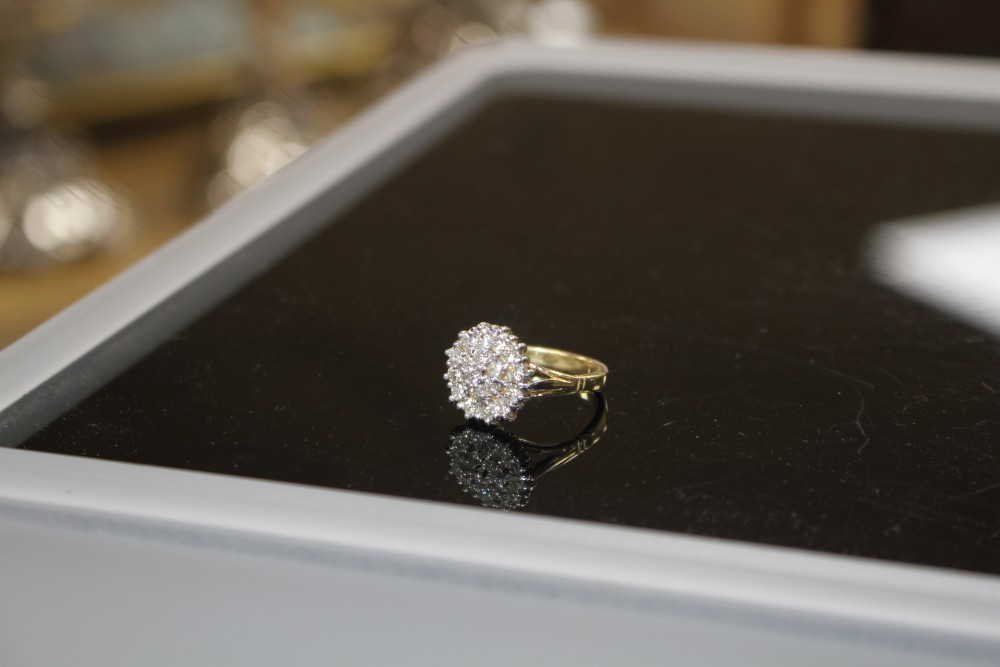 A modern 18ct gold and diamond cluster ring, size M, gross weight 7.8 grams.